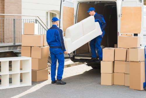 Removalist team loading furniture into a moving truck